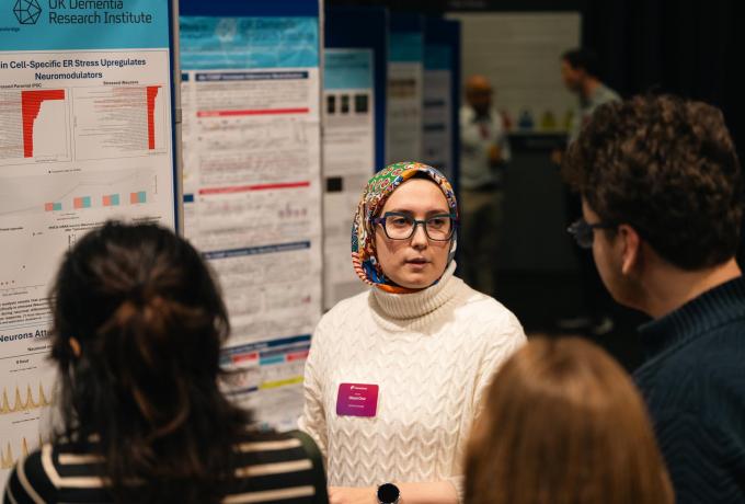 A scientist presents her research poster
