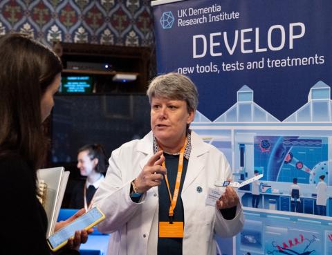 Scientist talks to an MP at the UK DRI parliamentary event