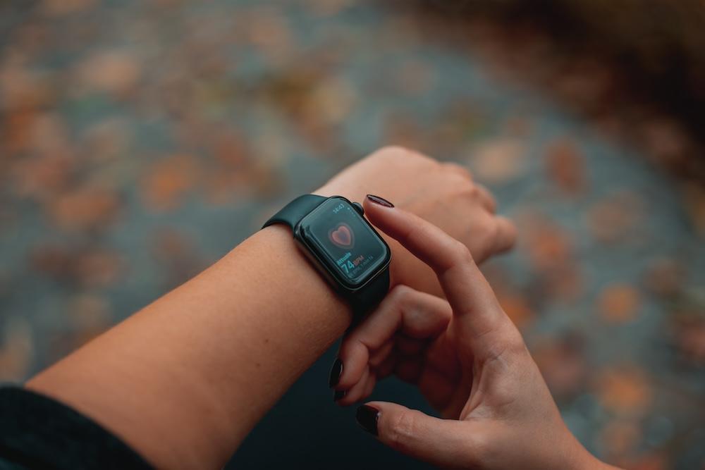 A woman looks at her smart watch